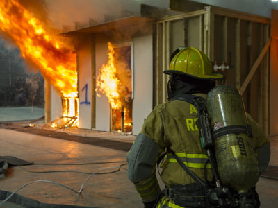 Certified fire investigator trainee observing a controlled fire during training