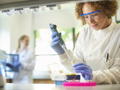 Researcher at a lab table transferring samples