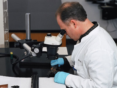 An examiner analyzes a firearm in the National Laboratory Center in Atlanta.