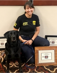 Donna kneeling next to her dog Brooklyn