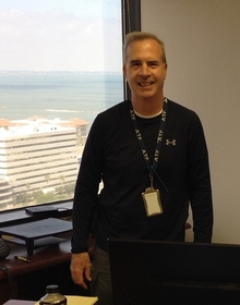 Stephen standing next to a window