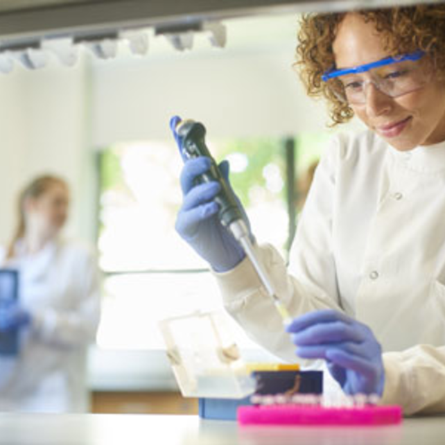 Researcher at a lab table transferring samples