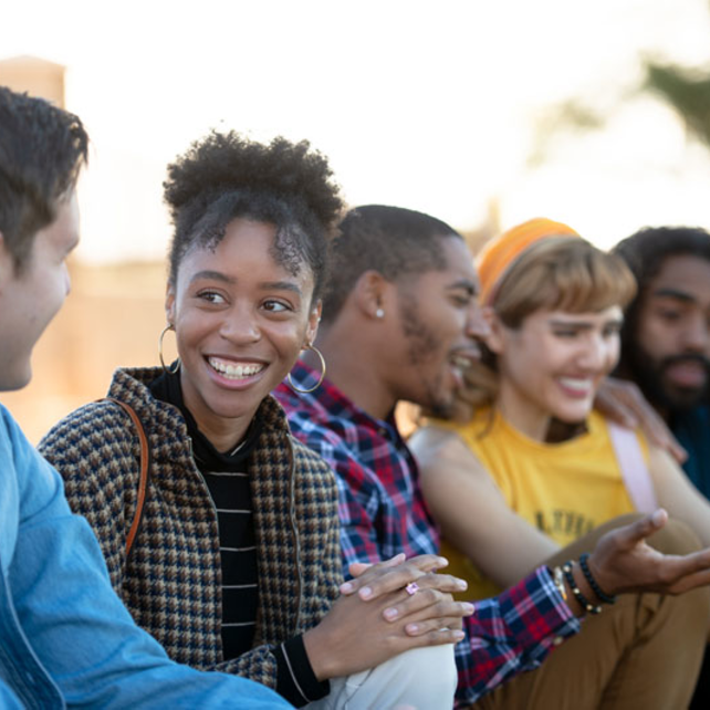 Female student interacting with a diverse group of friends