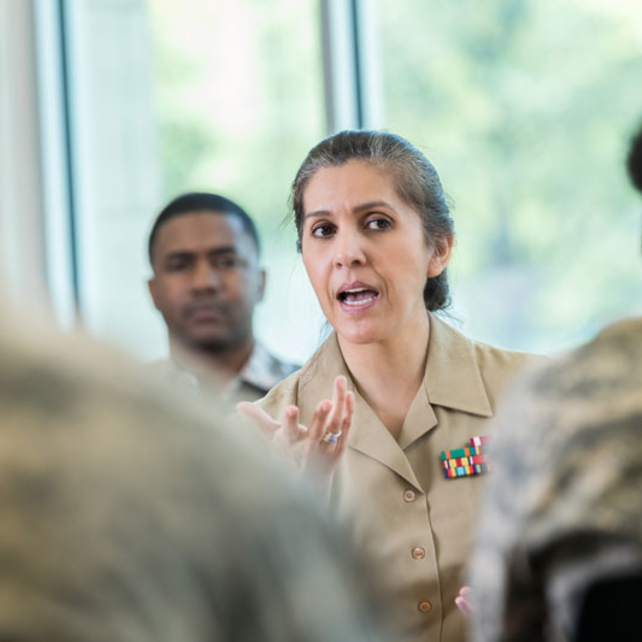 Female military member talking to troops