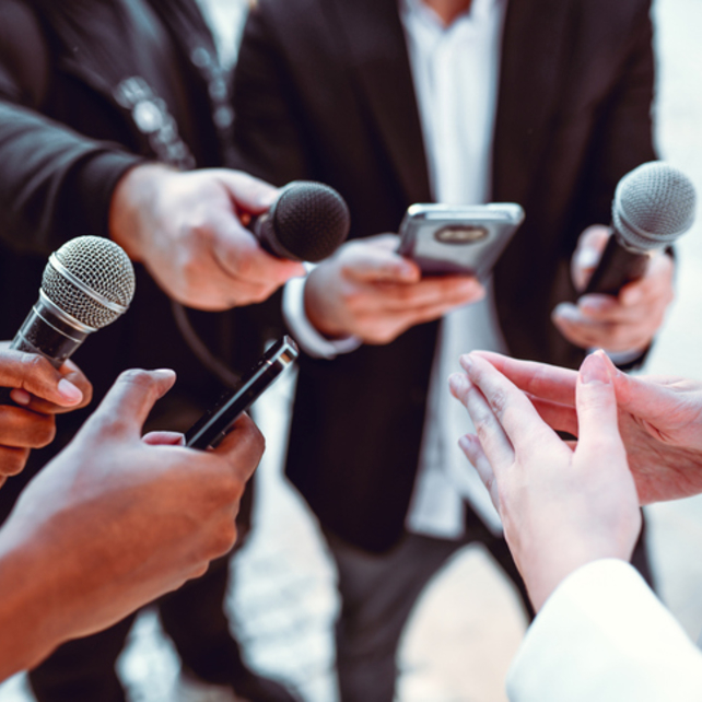 Press holding up microphones