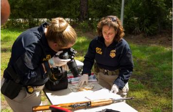 ATF special agents collect crime scene evidence