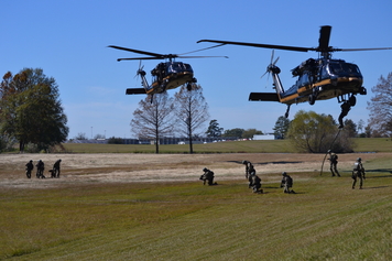 SRT members exiting helicopters as they hover