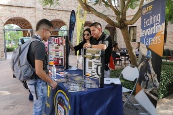 Edward talking to a visitor at a careers event