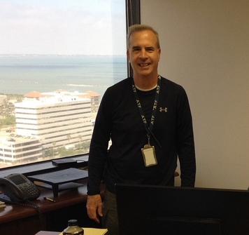 Stephen standing next to a window