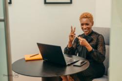 Woman communicating with sign language while looking at a laptop. Credit:  Disability:IN