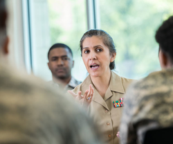 Female military member talking to troops