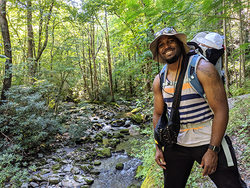 Dionte standing near a creek