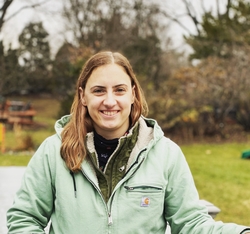 Emma standing in front of trees